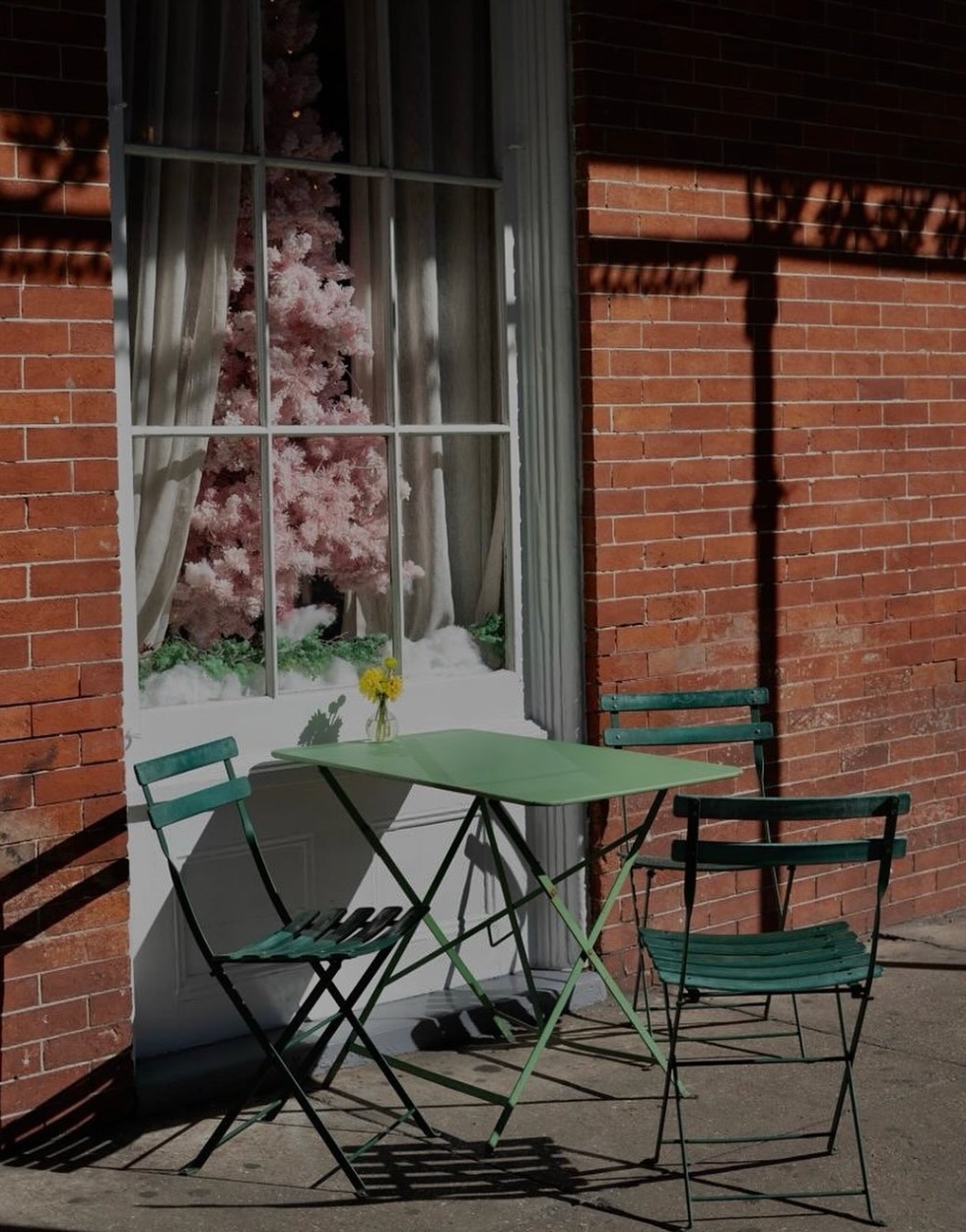 Café sidewalk with green bistro chairs