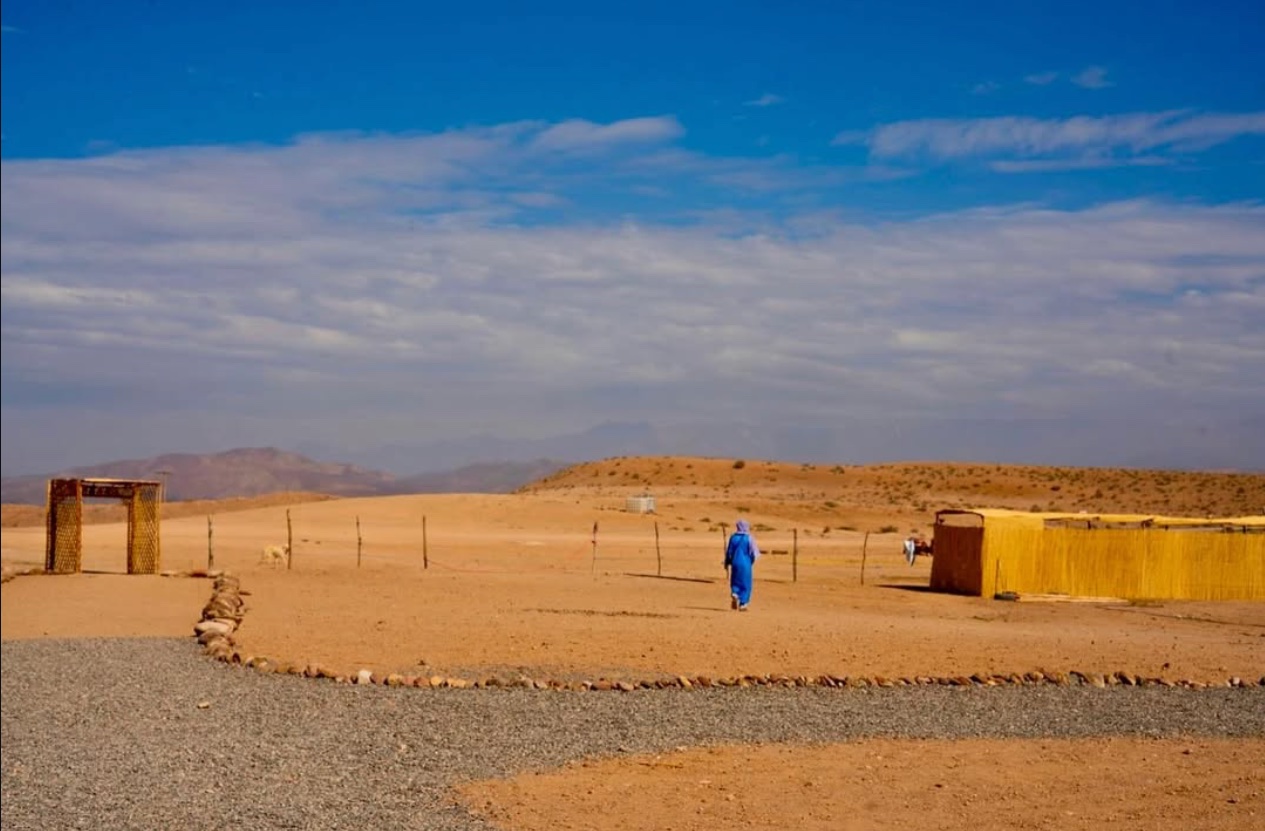 Desert landscape with figure in blue